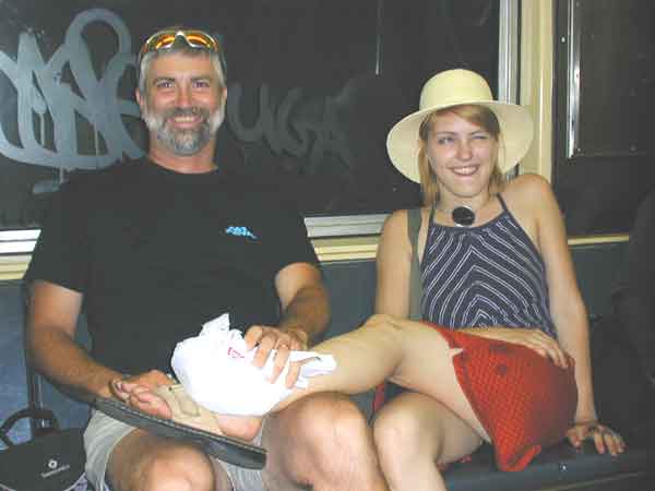 Rich and Danielle in the subway. The men on the trip were telling Danielle to walk off the fall down the stairs.